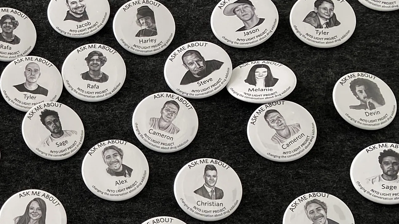 Buttons displaying the portraits of those lost to substance use disorder at the INTO LIGHT exhibit at the CSUSB Anthropology Museum.