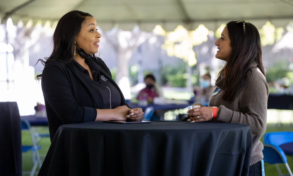 Danielle White, Program Manager, and Christina Hassija, Department Chair, Psychology, having a conversation.