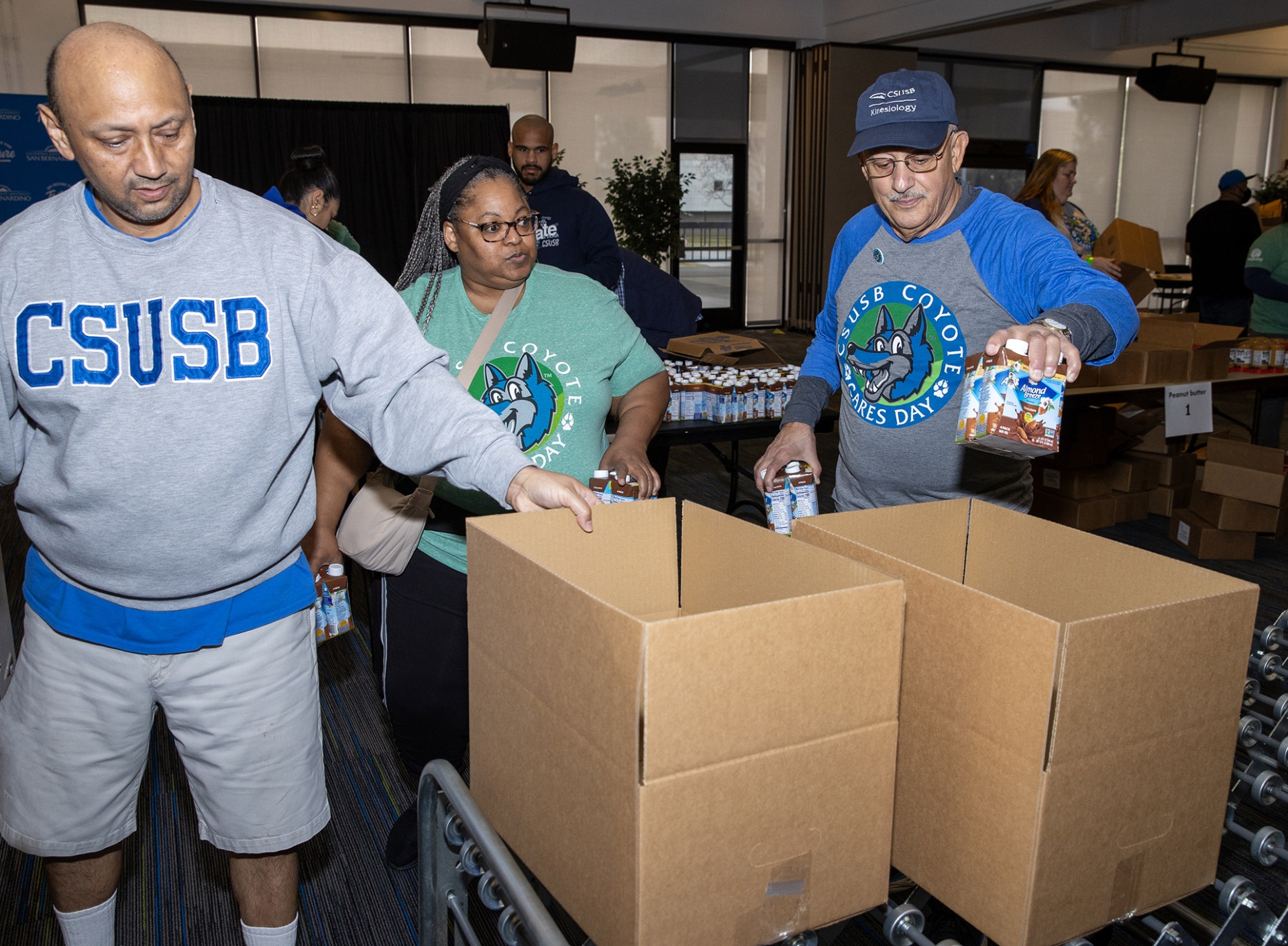 CSUSB President Tomás D. Morales (far right) was one of the volunteers who packed food for a local pantry during Coyote Cares Day on Feb. 17.
