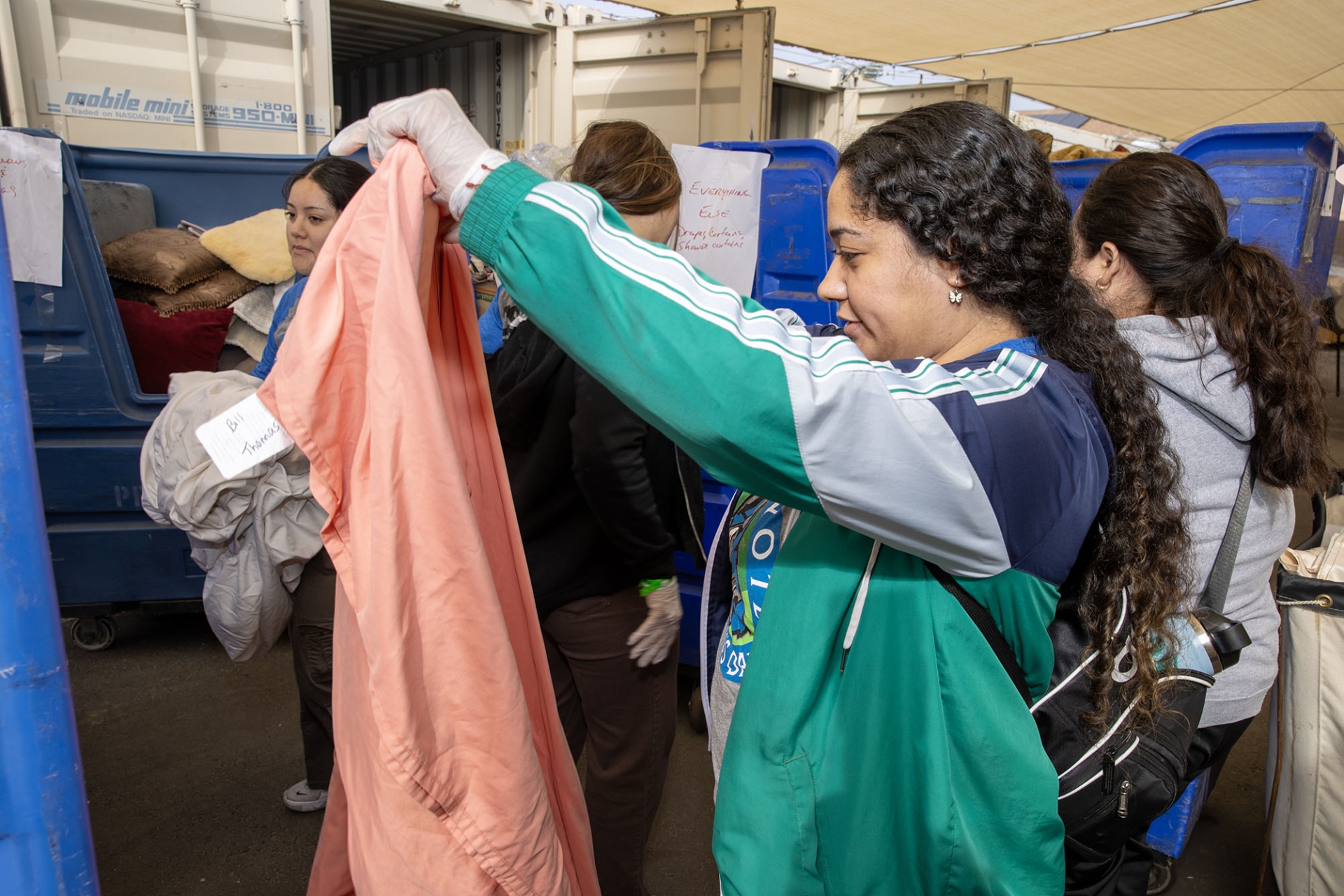 Clothes are sorted and folded at a San Bernardino-area agency during Cal State San Bernardino’s Coyote Cares Day, the university’s annual day of service to the community.