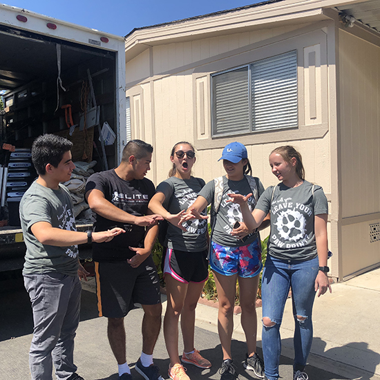 CSUSB volunteers cheering after painting the mobile.