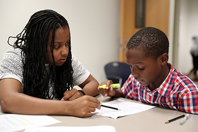 person teaching kid