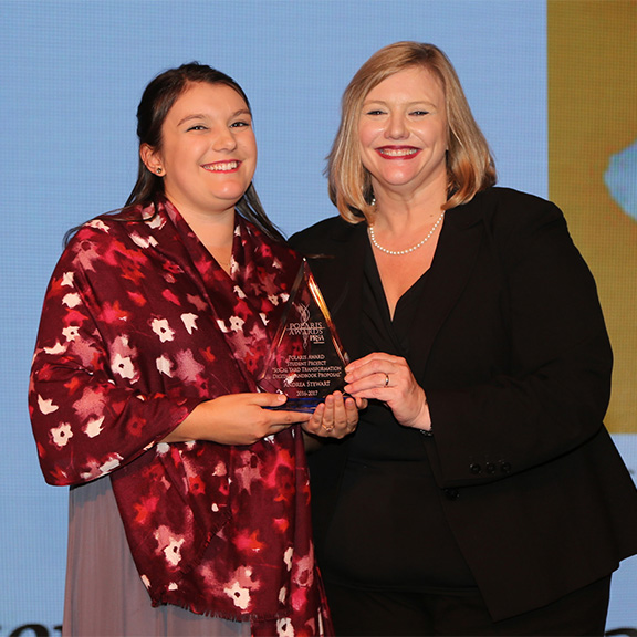 CSUSB student Andrea Stewart accepting Polaris award on stage with PRSA-Inland Empire President, Victoria Brodie.