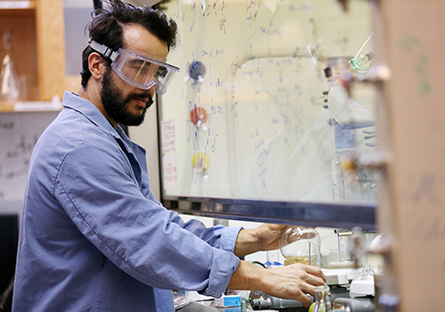 Chemistry faculty conducting an experiement