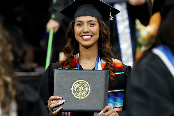 CSUSB graduate smiles with diploma
