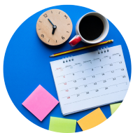 Calendar, post-it notes, clock, pencil, and coffee sitting on blue table