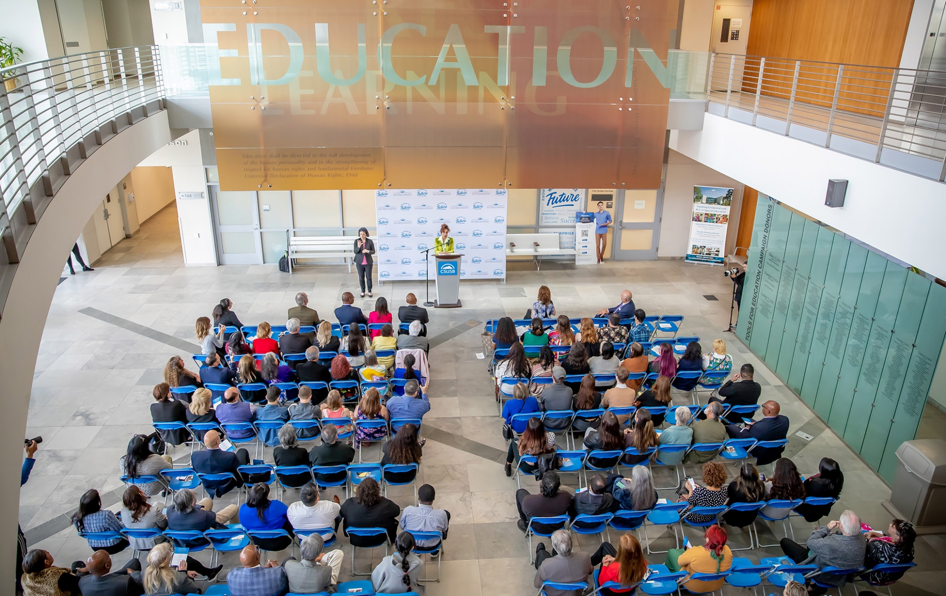 Speeches took place in the Watson College of Education atrium before the outdoor unveiling.