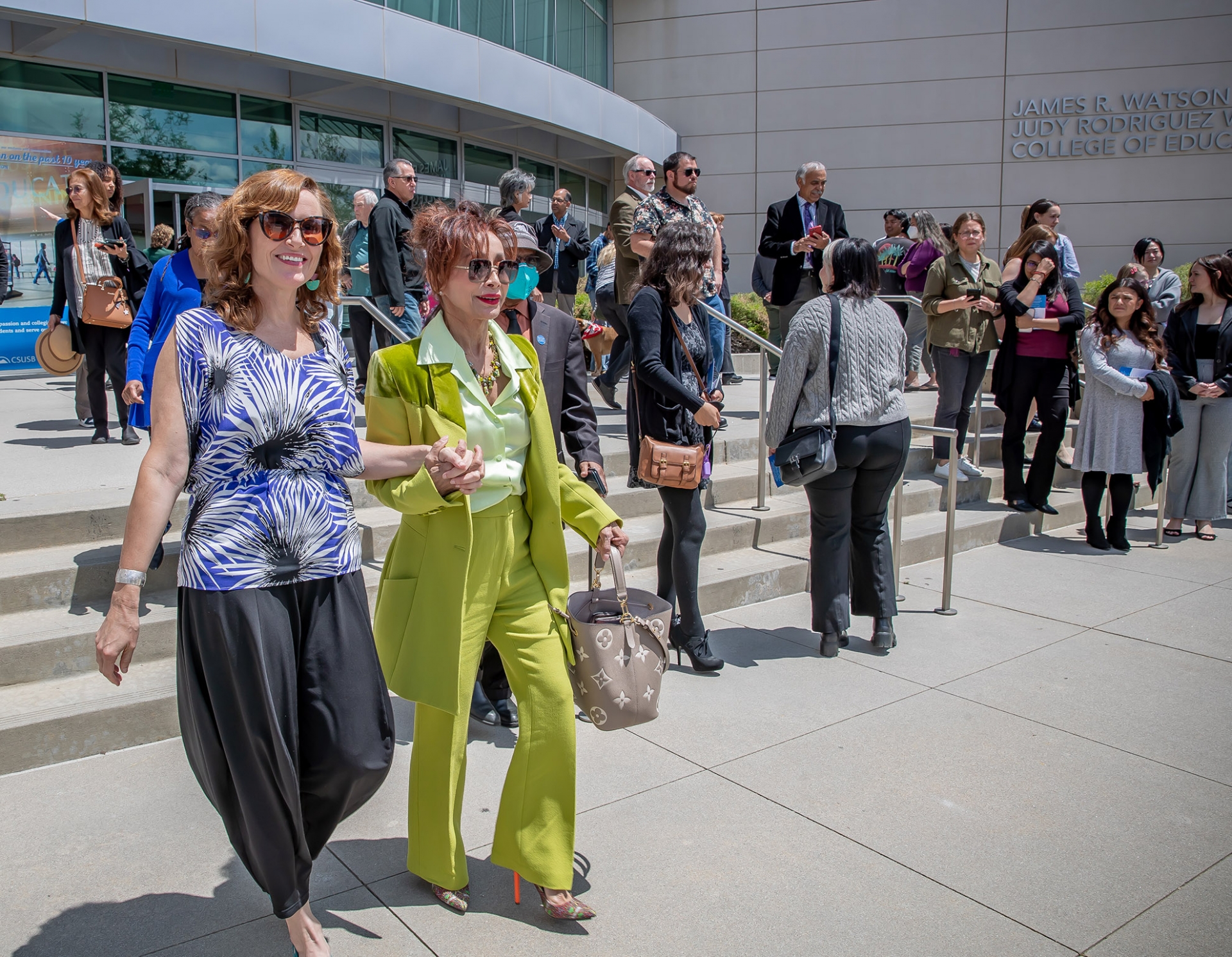 Alison Ragguette (left) and Judy Rodriguez Watson walk out of the atrium for the outdoor reveal.