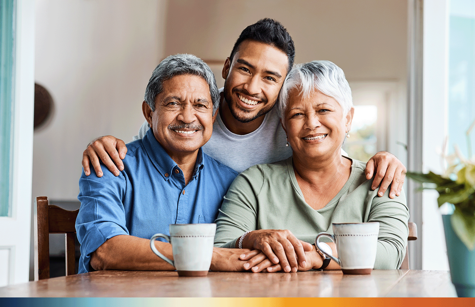 The Image shows a shot of a young son spending time with his parents at home. The son is standing with his father sitting on his left side and his mother sitting on his right.