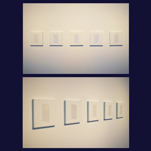 Acrylic paint and glass microspheres on wood panels. Five square white paintings with rectangular shapes on their surfaces that react to light and shadow.