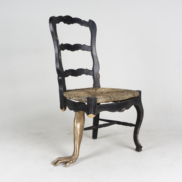 Chair with arm for one of its legs 