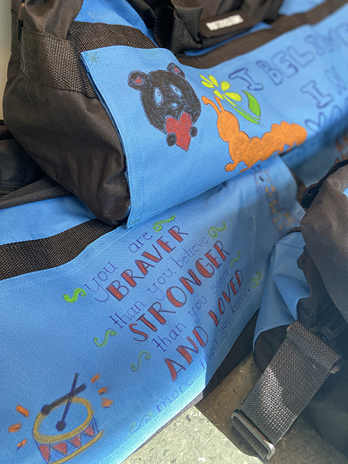 A picture of completed and decorated duffel bags.