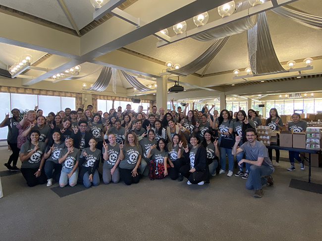 Group photo after packing more than 1000 boxes of food for CAPS.