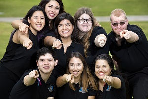 Students pointing at camera