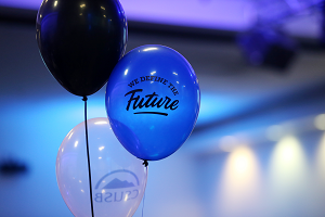 Photo of balloons with We Define the Future logo