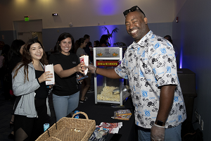 Photo of Bryant Fairley serving popcorn to student employees