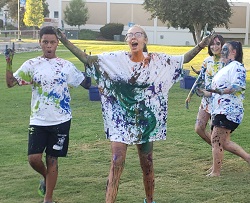 Students covered in paint playing Splatter Beat game