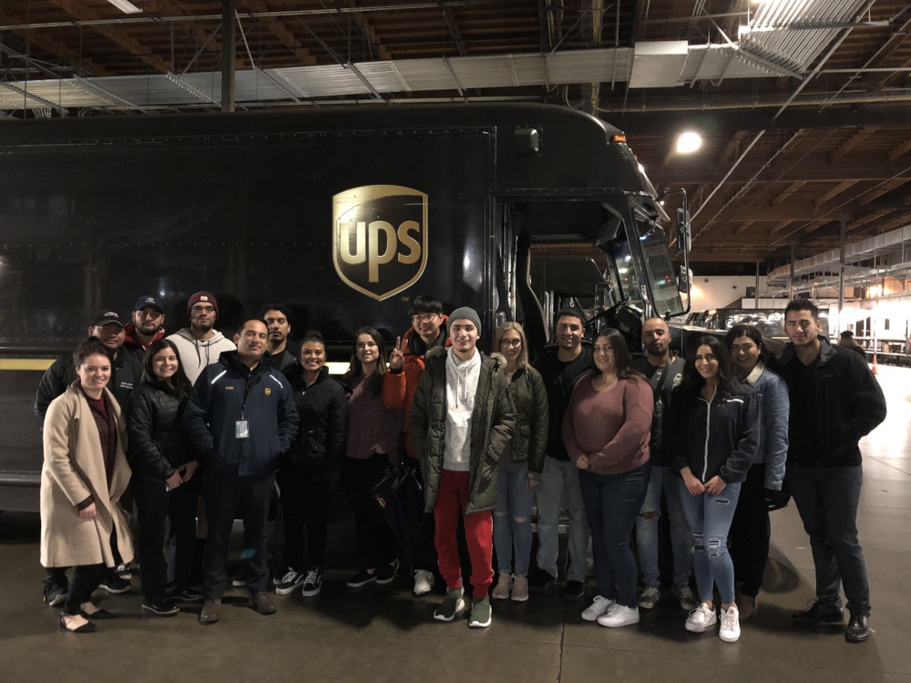 Group posing in front of UPS truck