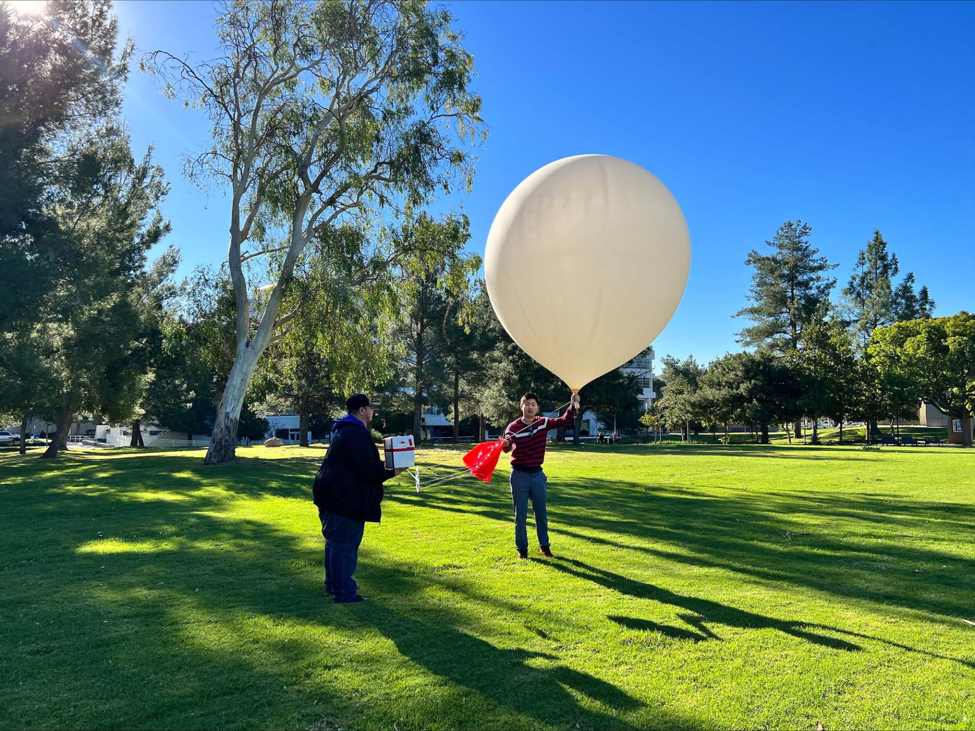 An ozonesonde balloon is readied for launch from the lawn next to the Chemical Sciences building on the CSUSB campus.