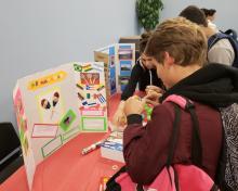 Students creating cultural item at Heritage Month Celebration