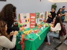 Students creating cultural item at Heritage Month Celebration