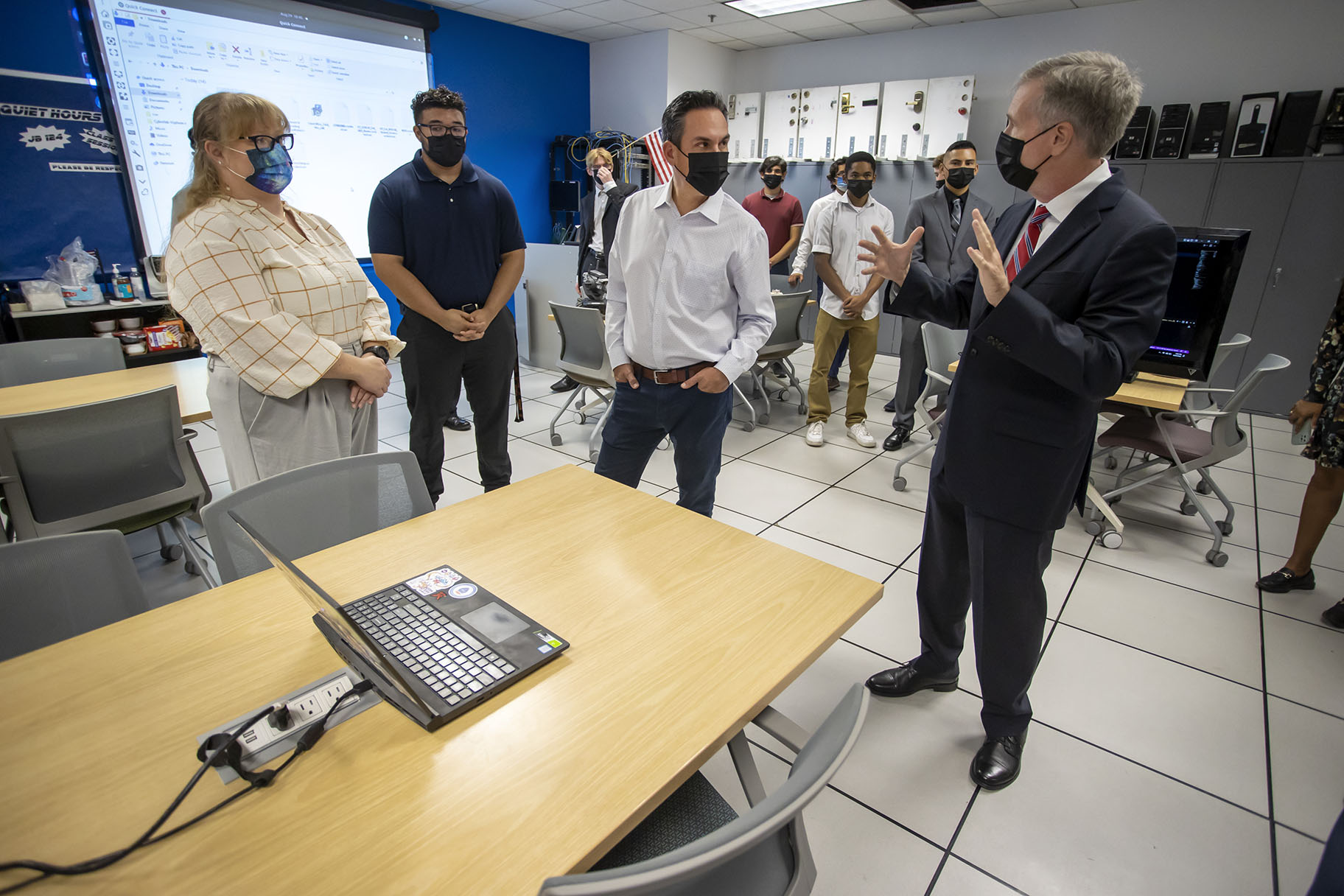 Aubrie Kendall, Intern, Cyber Halo Innovation Research Program (CHIRP), and Student, CSUSB, an unidentified student, Congressman Pete Aguilar and Tony Coulson, CSUSB professor at the Cybersecurity Center.