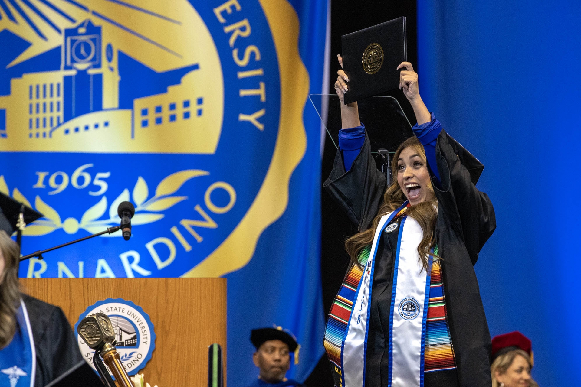 A student celebrates at fall 2022 commencement.