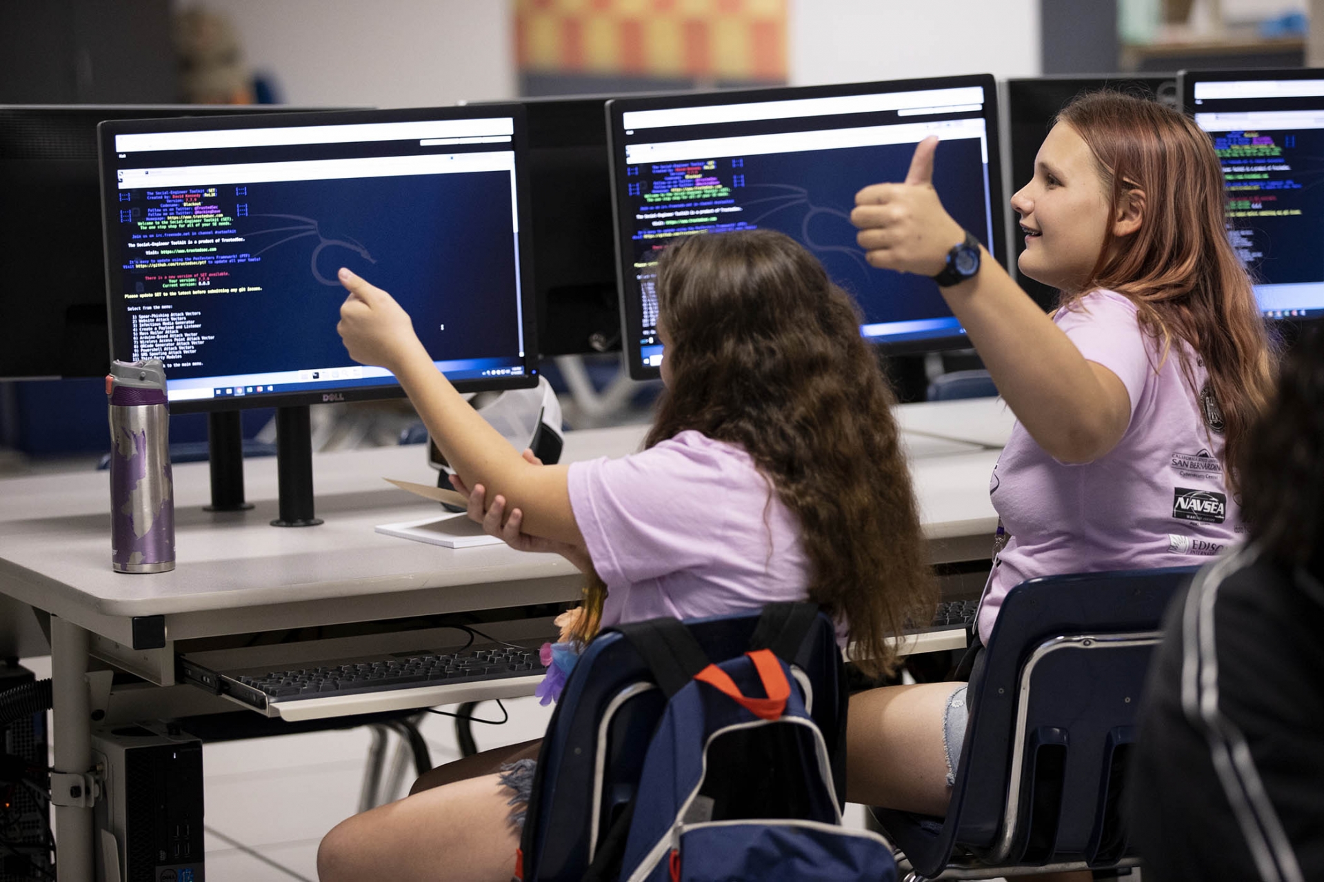 Two GenCyber Camp participants give a thumbs up.