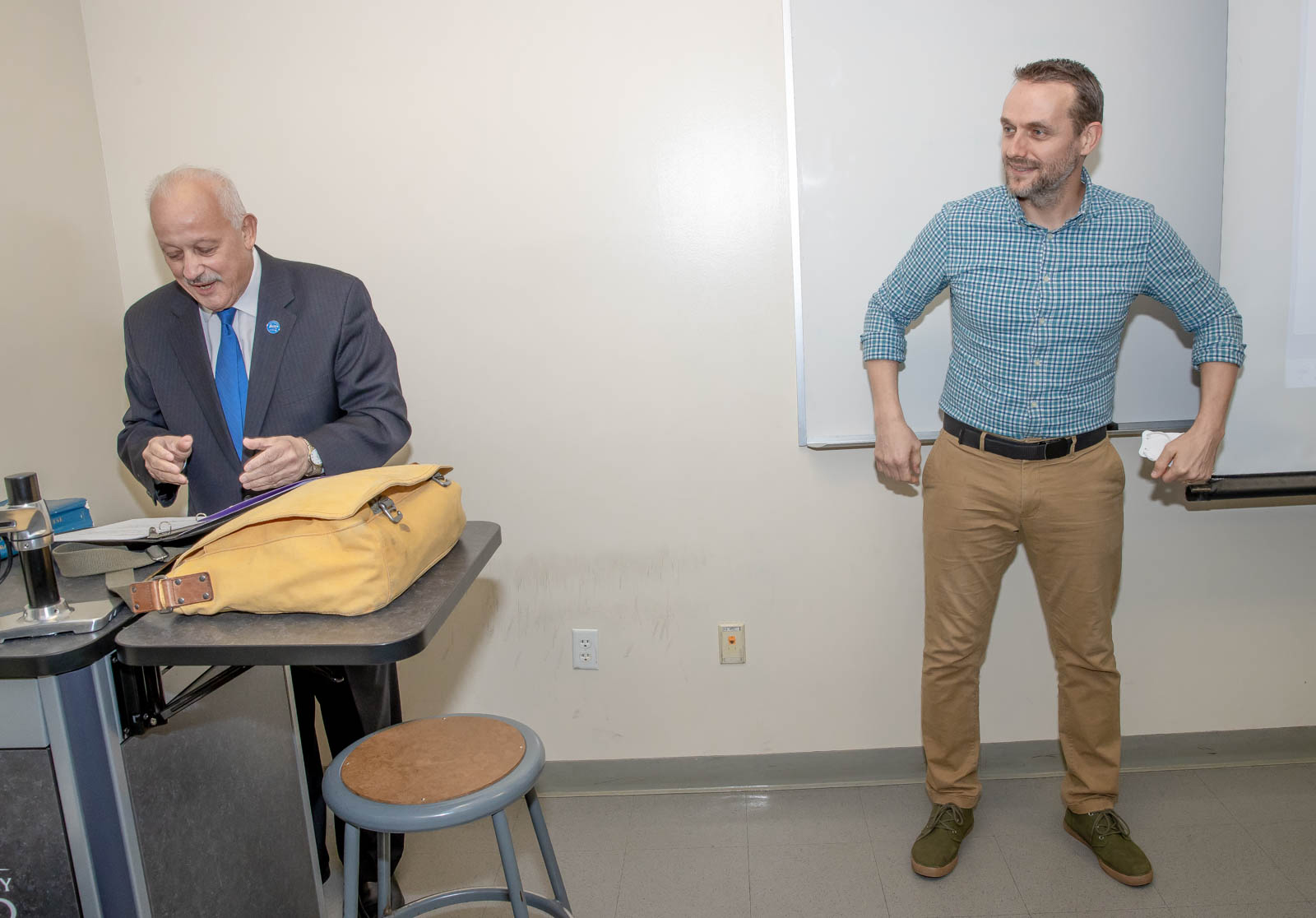 : President Tomás D. Morales (left) announces to Jeremy Murray and his students, many of whom were on Zoom, that Murray is the recipient of the university’s 2022-23 Outstanding Service Award.