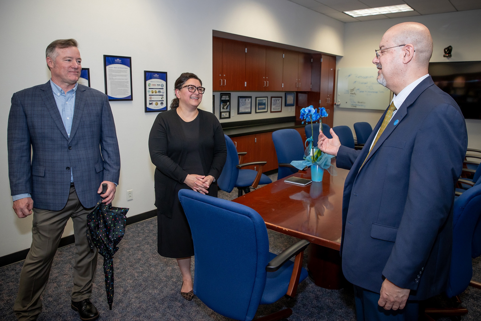 Robert Stokes (left), chair of the public administration department, left, and Tomas Gomez-Arias (right), dean of the Jack H. Brown College of Business and Public Administration, chat with Sharon Velarde Pierce, associate professor of public administration and the recipient of the 2022-23 Outstanding Faculty Advisor Award.>>