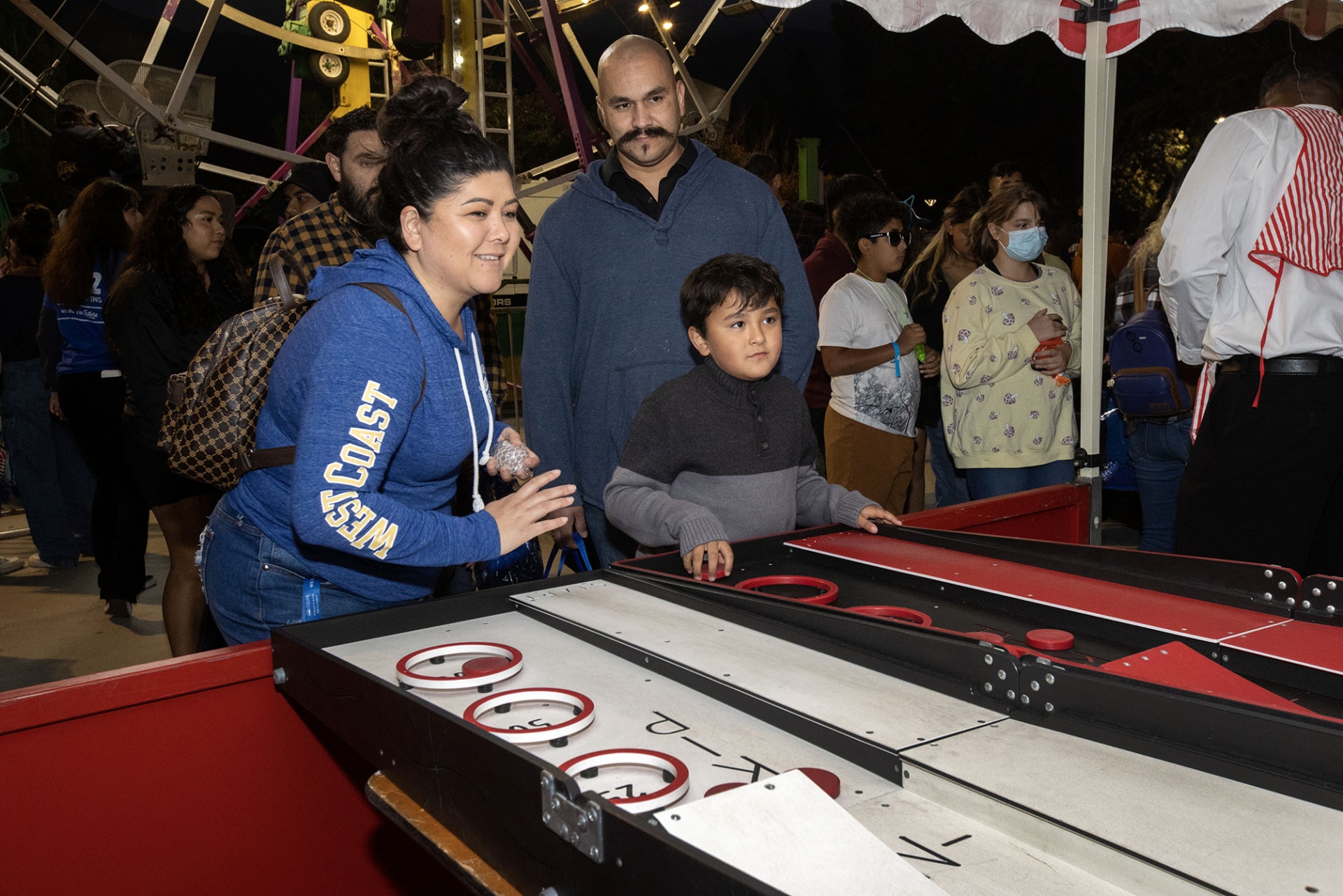 A family enjoying a game at Homecoming Bash.