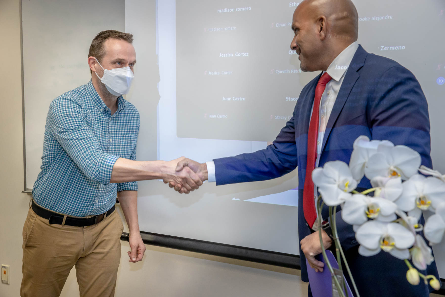 Jeremy Murray, recipient of the university’s 2022-23 Outstanding Service Award, is congratulated by Rafik Mohamed, provost and vice president of Academic Affairs.