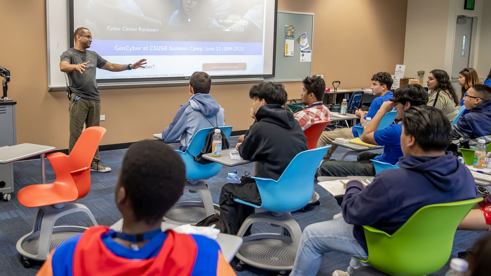 Charles Rouse, CSUSB GenCyber Camp program manager, speaks with the students about computer technology and cybersecurity at the Jack H. Brown College for Business and Public Administration at CSUSB.