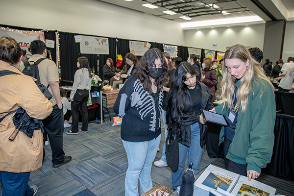 Some of the more than 1,200 students attending the 2023 Virtual Enterprise International – West Coast Regional Tradeshow, Competition and Exhibition look through exhibits.