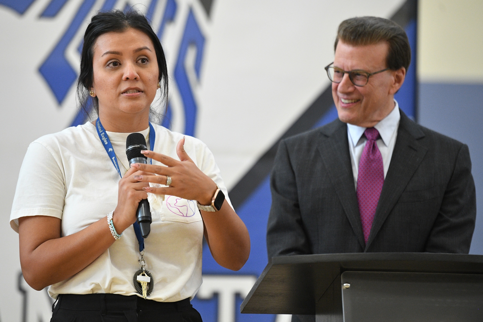 With Milken Educator Awards Founder Lowell Milken (at right) looking on, recipient Alexis Arias thanks the students, colleagues and visitors who just witnessed her surprise notification. Photo courtesy of Milken Family Foundation.