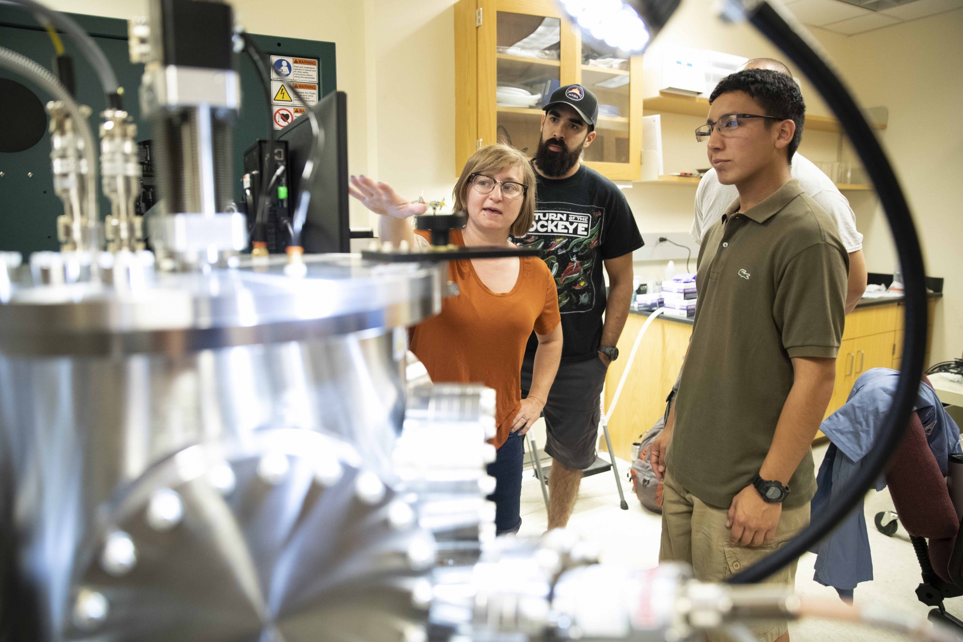Sara Callori (l), associate professor of physics, works with students on the axis magnetron sputter deposition system in July 2019. Callori is one of the co-principal investigators for the National Science Foundation’s International Research Experiences for Students grant at CSUSB.