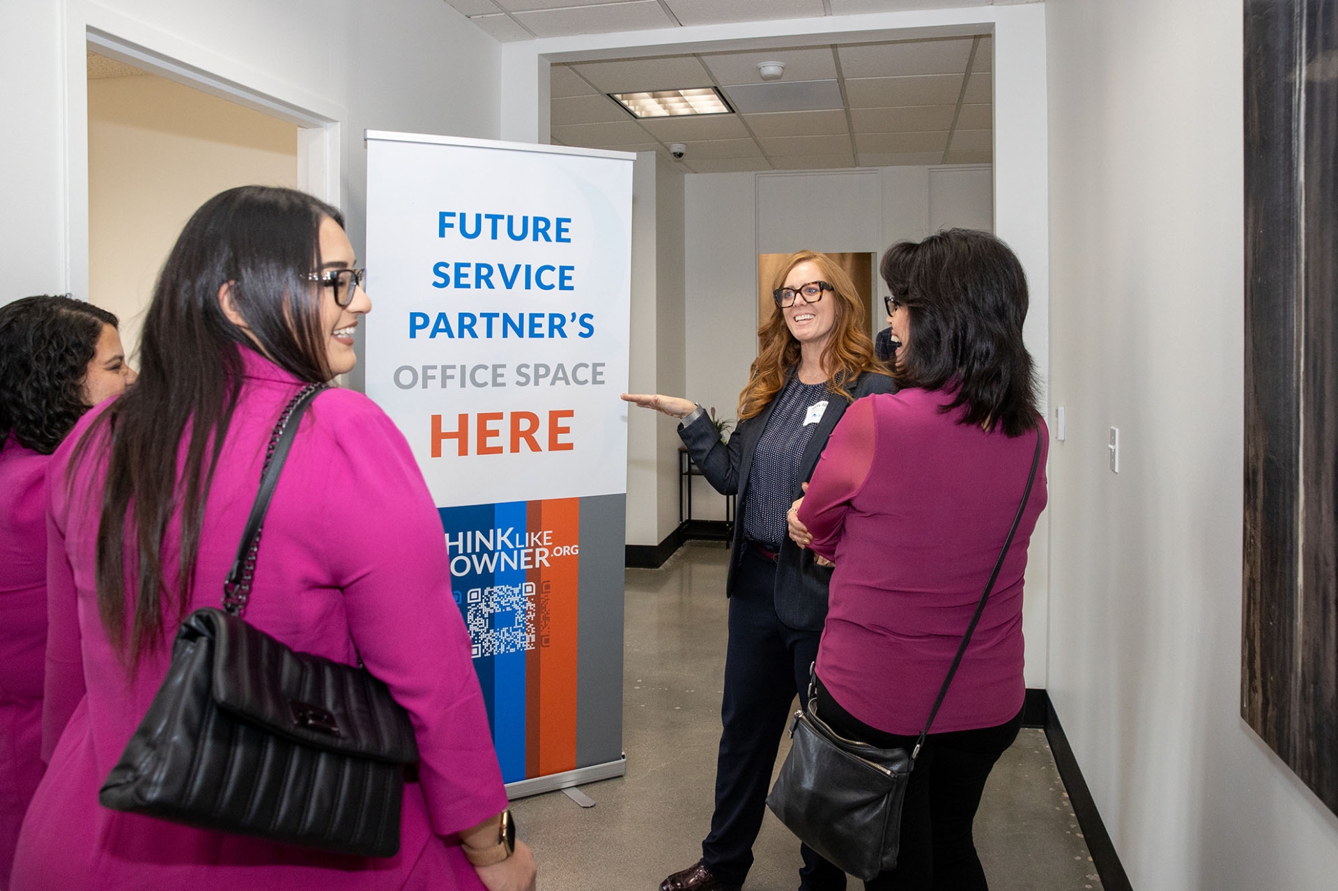 Stacey Allis (second from right), assistant director of the IECE, gives a tour of the Entrepreneurial Resource Center during its grand opening celebration.