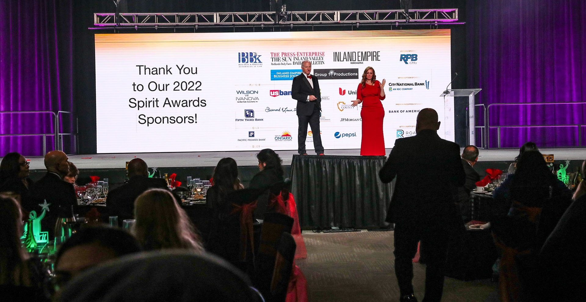 Spirit award sponsors are displayed on signage on the stage.
