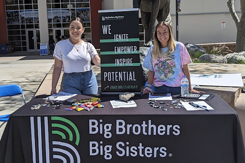 Bianca Gonzalez (left) and Evelyn Atencio encourage CSUSB students to join Big Brothers Big Sisters. 