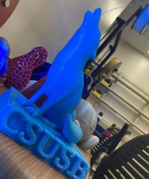 Image of a blue 3d printed coyote logo.