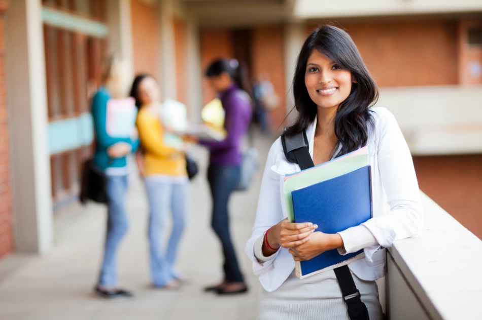 Female student holding books.