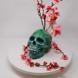 decorated calavera with flower and leaves