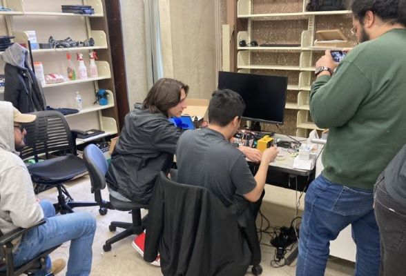 Library Innovation Assistants work on an electronics project.