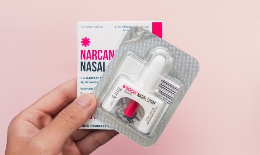 A hand holding Narcan