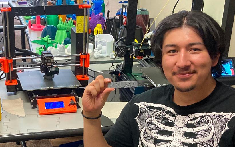 LIT student Armando Felix holds up a 3d printed Prusa logo