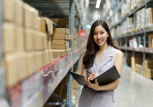 Woman looking at folder in a warehouse