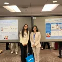 Honor student Camryn Amundsen and URISE student Britney Aguire proudly pose next to their respective posters.
