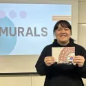 Student showing their miniature mural
