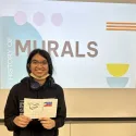 Student showing their miniature mural