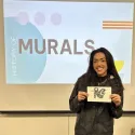 Student showing their miniature mural